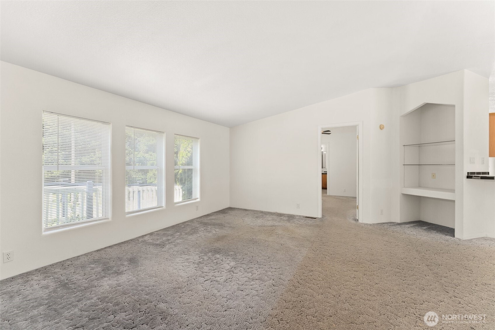 312 McGlaughlin Road Winlock, WA 98596 - Photo 4 of 40 an empty room with a fireplace and windows