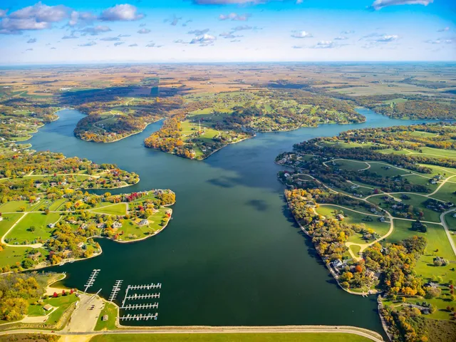 an aerial view of a house with a lake