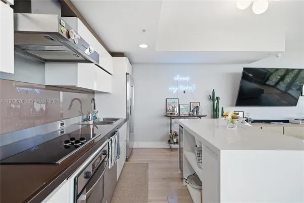 a kitchen with stainless steel appliances a sink and a stove