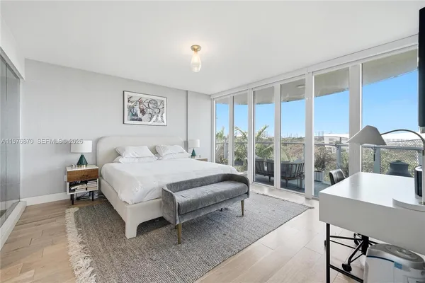a spacious bedroom with a bed and a table