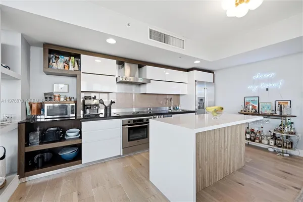 a kitchen with a sink a stove and cabinets