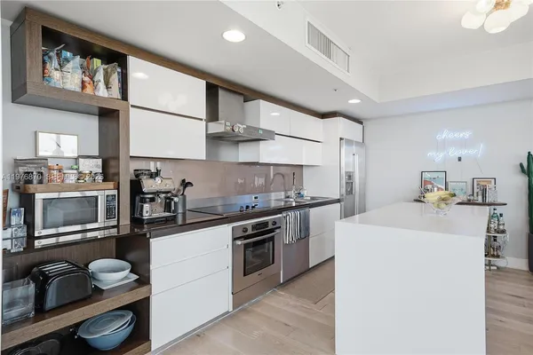 a kitchen with stainless steel appliances a sink stove and cabinets