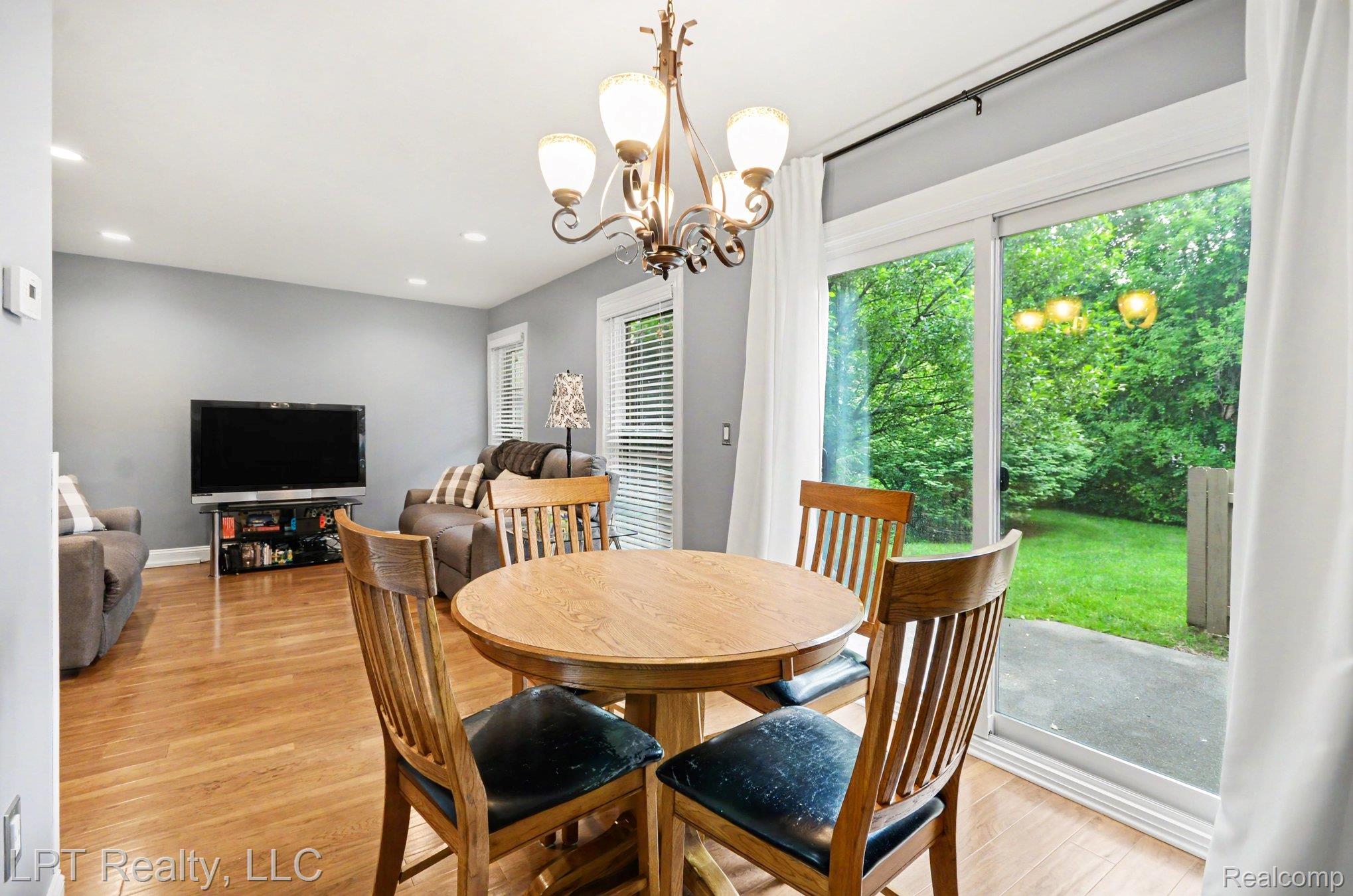 829 Langdon Court Rochester, MI 48307 - Photo 13 of 31 Open-concept living area featuring Luxury Vinyl Plank flooring, a contemporary chandelier, and recessed lighting