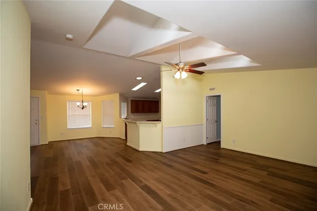 an empty room with wooden floor and door