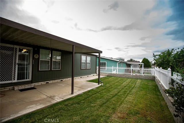 a backyard of a house with table and chairs