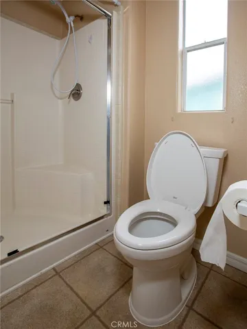 a bathroom with a shower and a toilet