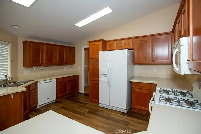 a kitchen with stainless steel appliances granite countertop a refrigerator stove and sink
