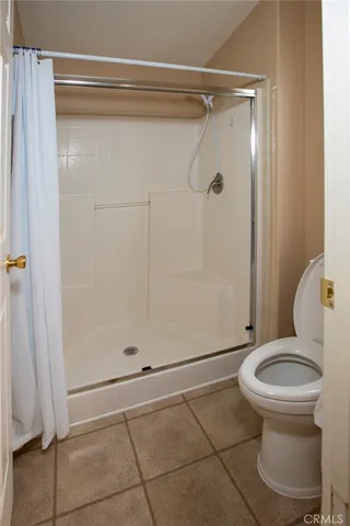 a view of empty room with wooden floor and cabinet