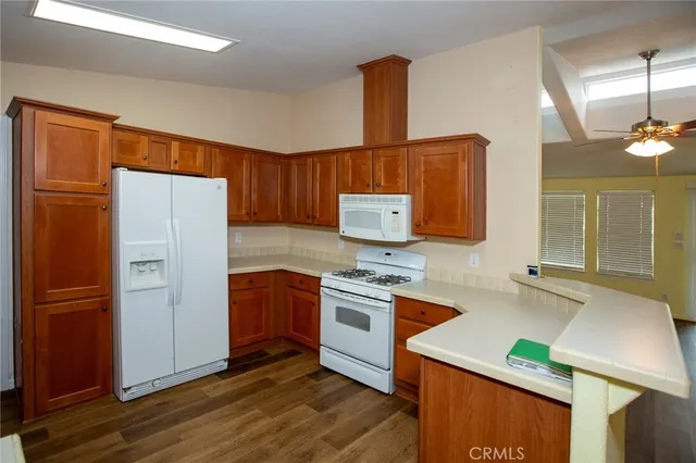 a kitchen with stainless steel appliances granite countertop a refrigerator sink and cabinets