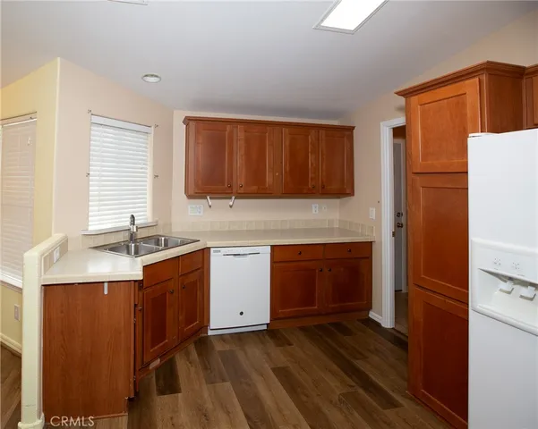 a view of a kitchen with cabinets and wooden floor