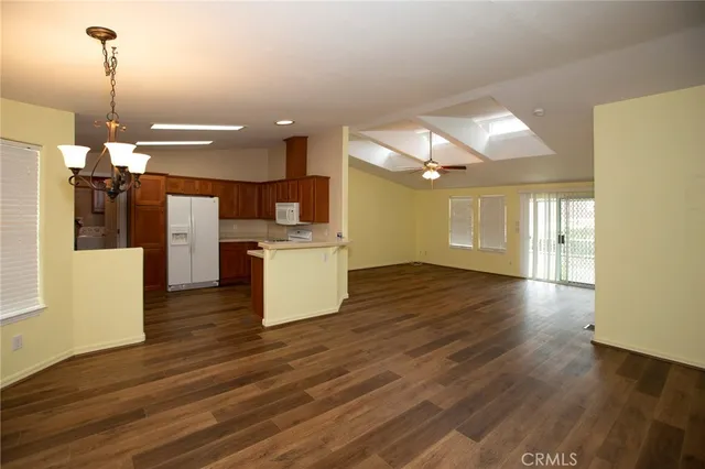 a view of a kitchen with wooden floor and a sink