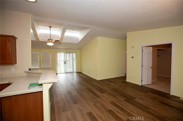 a view of a livingroom with a ceiling fan and window