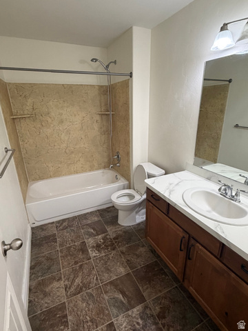 909 South Main Street, Unit F Layton, UT 84041 - Photo 7 of 20 Bathroom featuring a full vanity with a white countertop and integrated sink, a large mirror, and a bathtub with a shower and textured surround