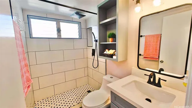 a bathroom with a sink toilet and shower