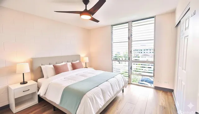 a bedroom with a large bed and a large window