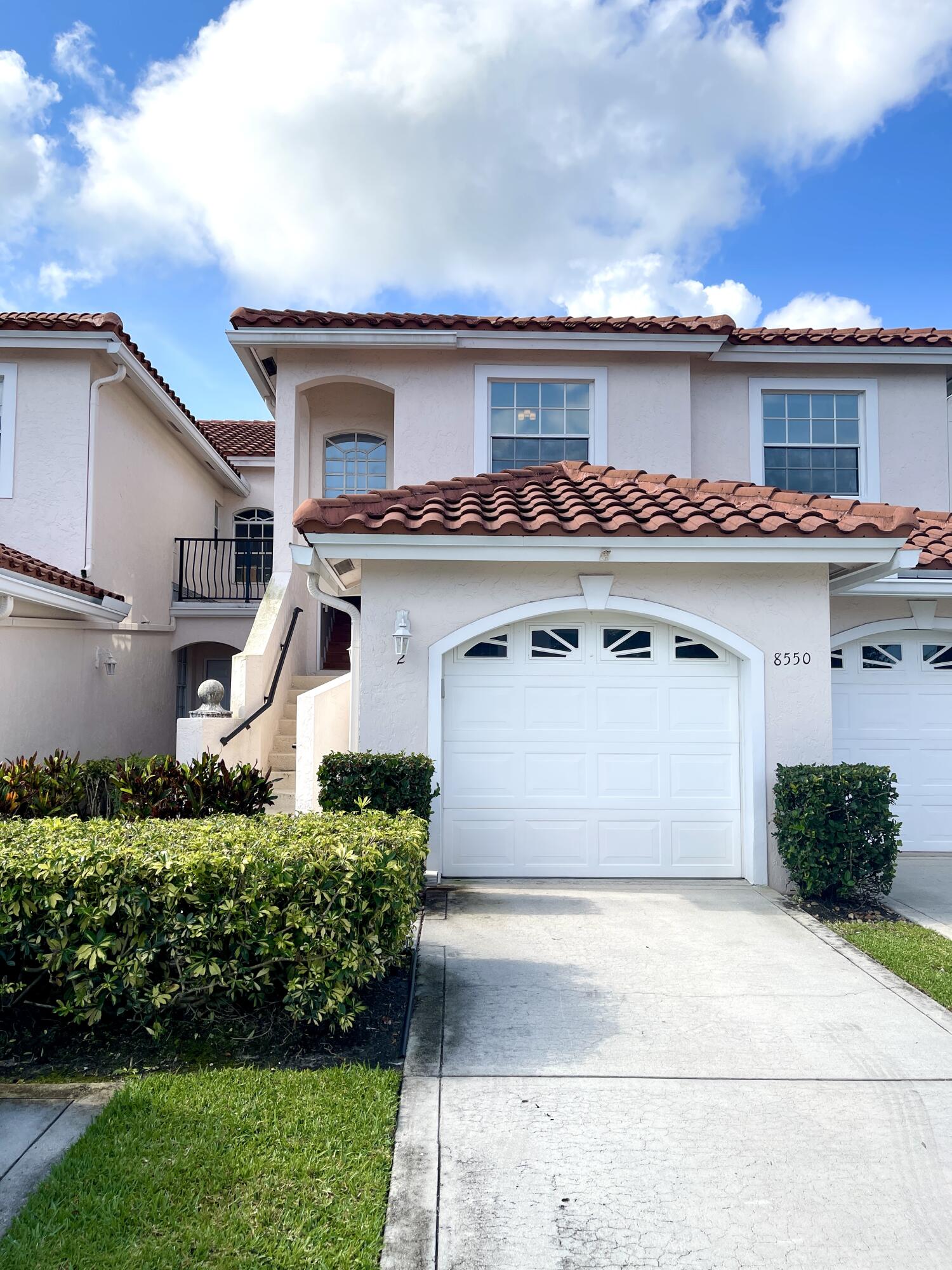 8550 Vía Romana, Unit 2 Boca Raton, FL 33496 - Photo 1 of 28 a front view of a house with a garden
