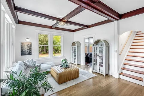 a living room with furniture and wooden floor