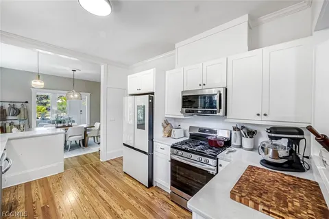 a kitchen with sink cabinets and wooden floor