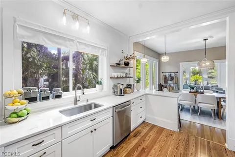 a kitchen with cabinets and window