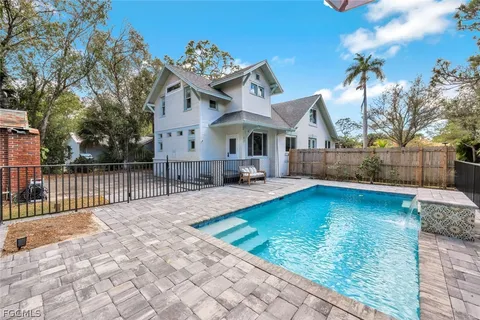 a view of a house with backyard and sitting area