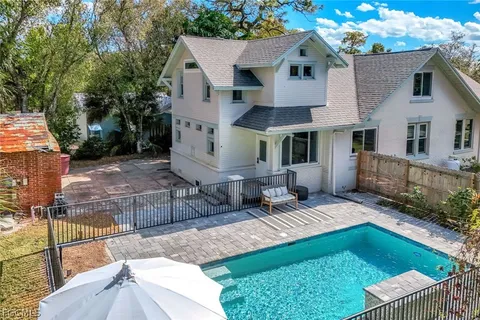 an aerial view of a house with a yard and trees