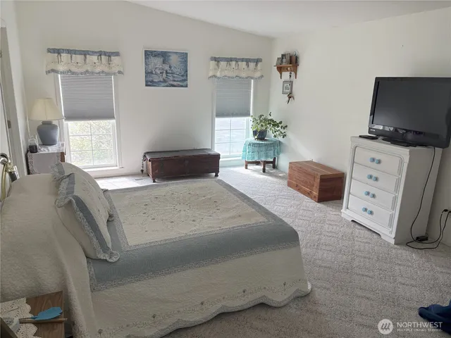 a bedroom with a bed and flat screen tv
