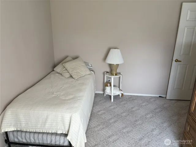a bedroom with a bed and flat screen tv