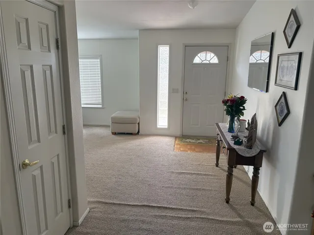 a view of hall way with mirror and furniture