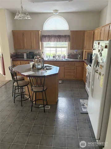 a kitchen with stainless steel appliances a sink a counter top space and a window