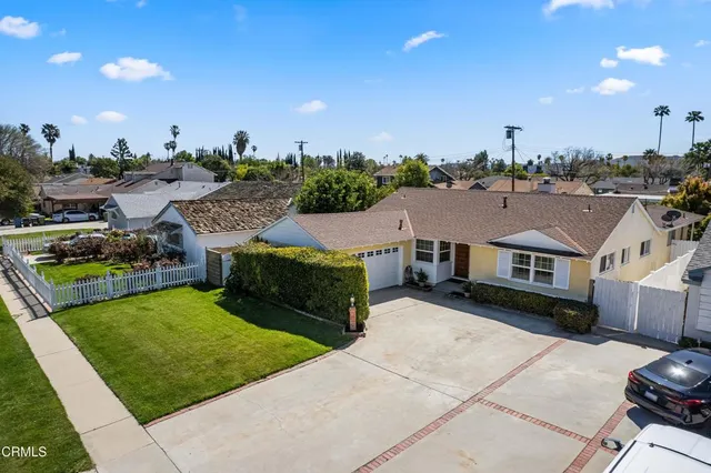 a view of a house with a yard and sitting area