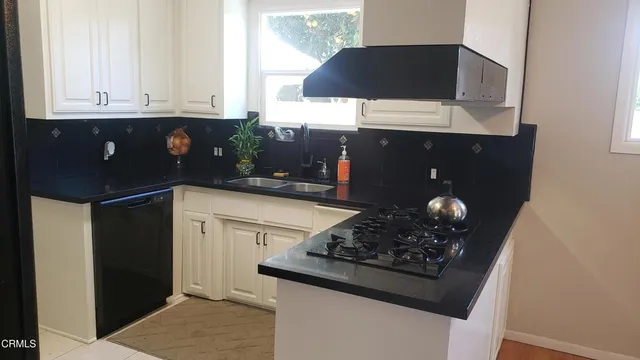 a kitchen with stainless steel appliances granite countertop a refrigerator a stove and a refrigerator