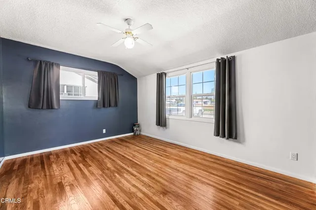a bedroom with a large bed couch and a window
