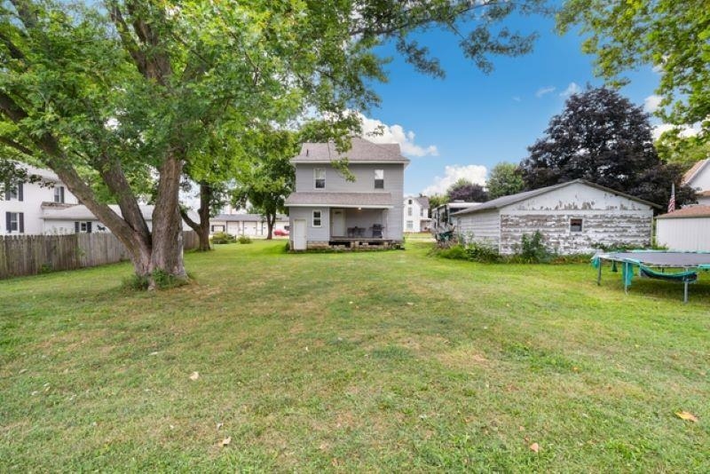 210 North Main Street Tampico, IL 61283 - Photo 3 of 10 a view of a house with a big yard and large trees