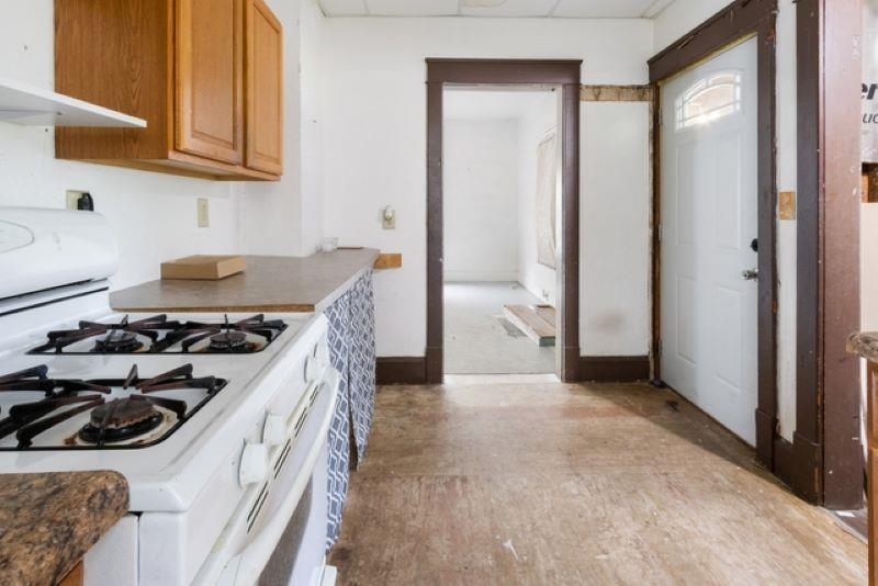 210 North Main Street Tampico, IL 61283 - Photo 6 of 10 a kitchen with a stove and a refrigerator