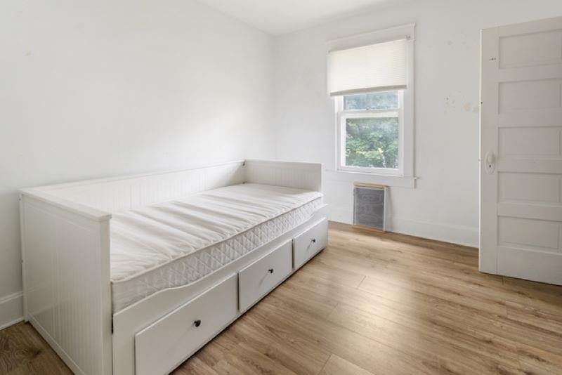 210 North Main Street Tampico, IL 61283 - Photo 9 of 10 a spacious bedroom with a bed and a window