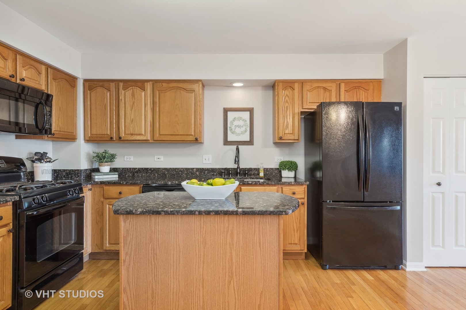 1338 Filly Lane Bartlett, IL 60103 - Photo 5 of 18 a kitchen with granite countertop stainless steel appliances a refrigerator a stove a sink and a cabinets