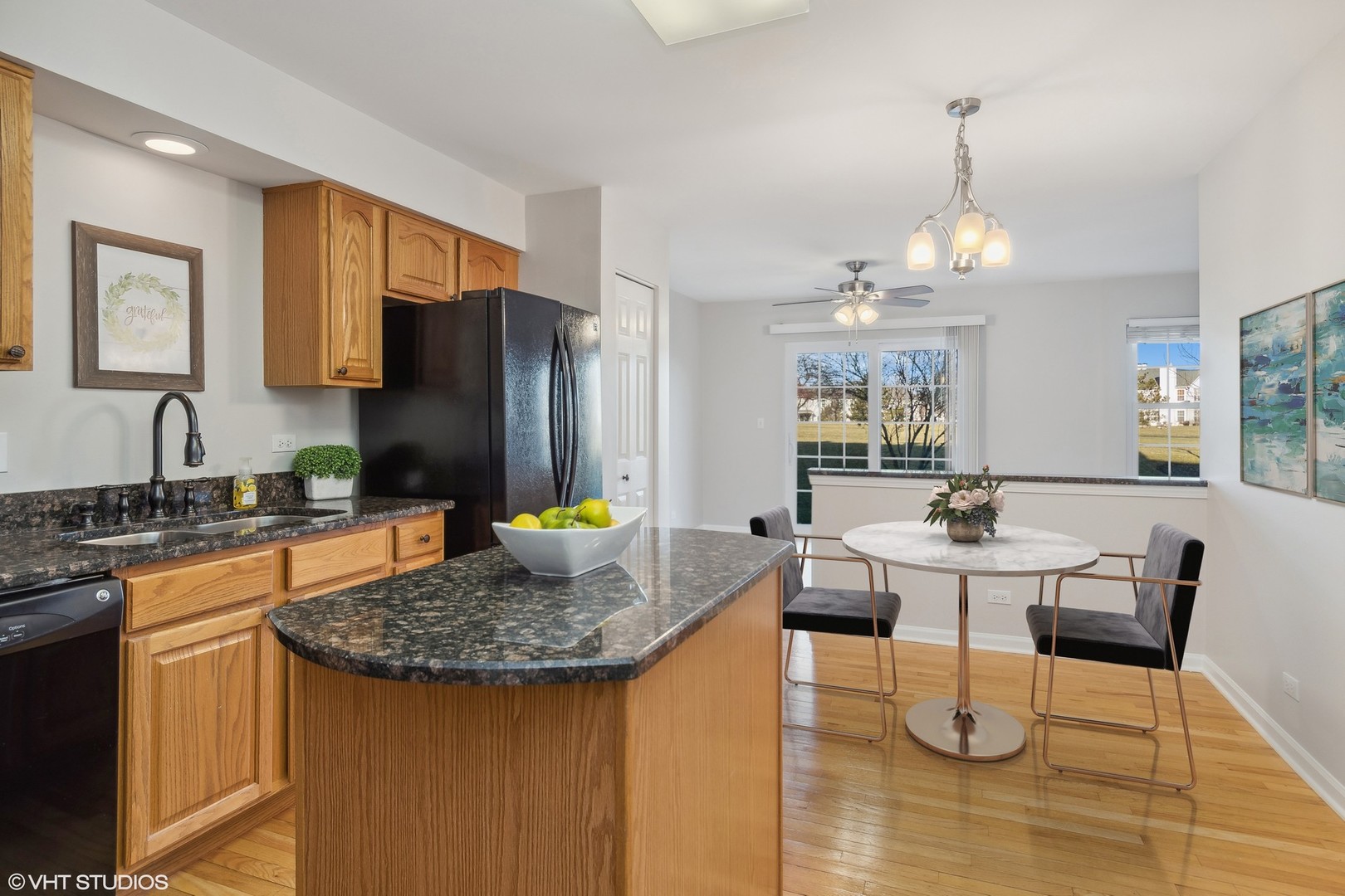 1338 Filly Lane Bartlett, IL 60103 - Photo 6 of 18 a kitchen with sink refrigerator dining table and chairs