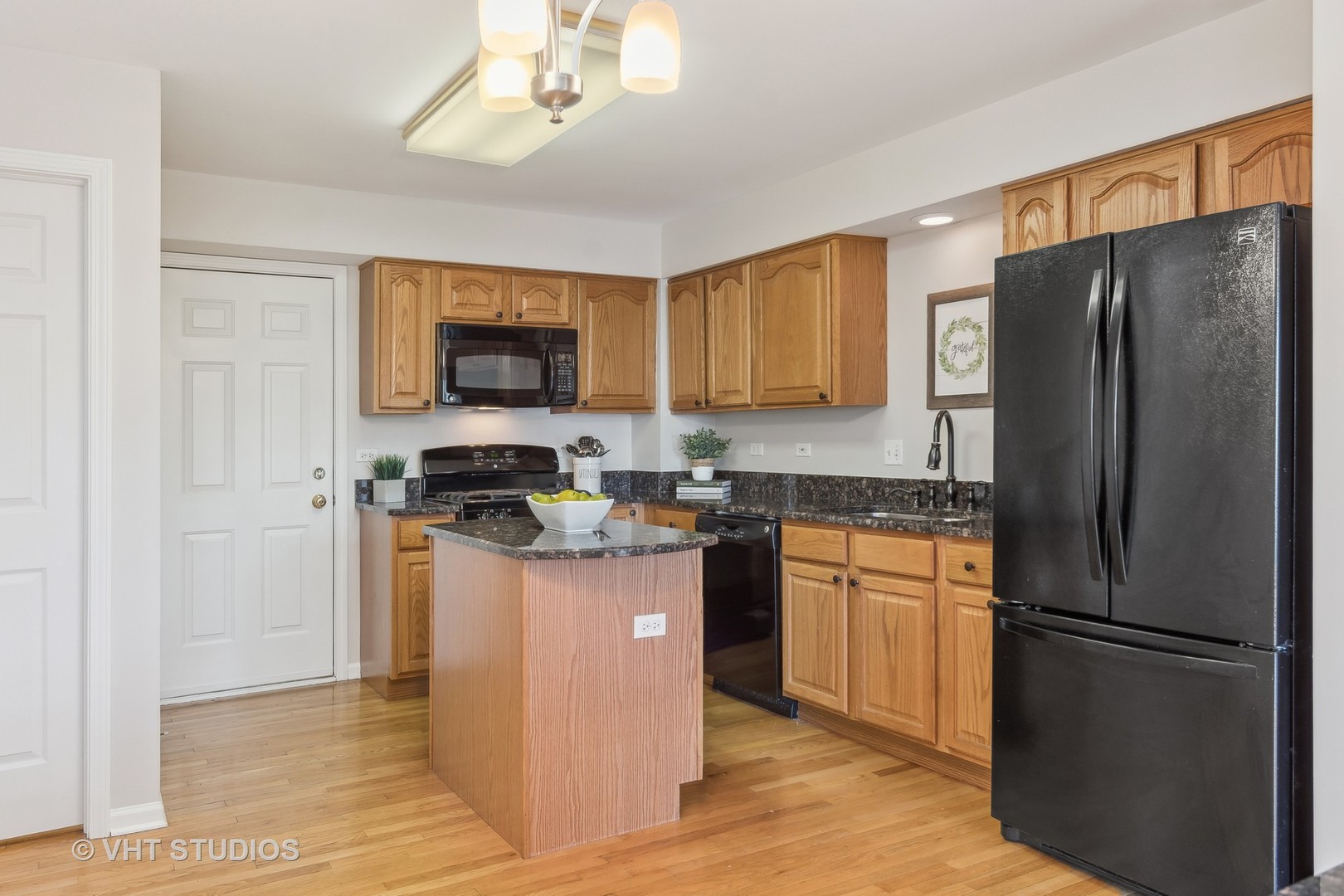 1338 Filly Lane Bartlett, IL 60103 - Photo 7 of 18 a kitchen with stainless steel appliances granite countertop a refrigerator a stove a sink and a microwave