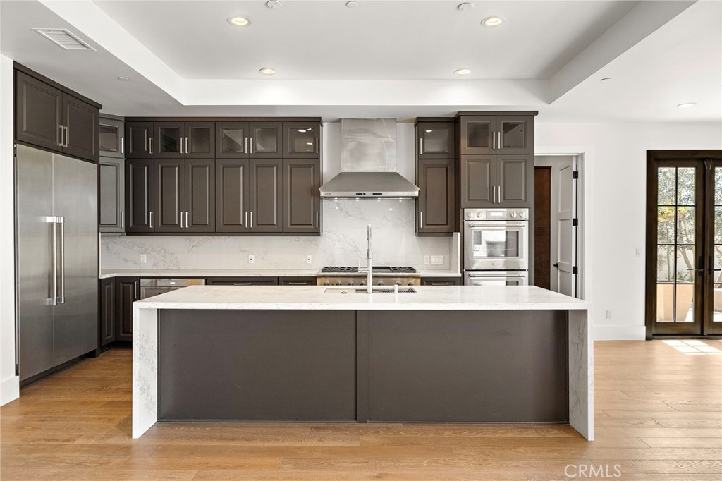 7 Alexa Lane Ladera Ranch, CA 92694 - Photo 22 of 75 a kitchen with stainless steel appliances granite countertop a sink stove and refrigerator
