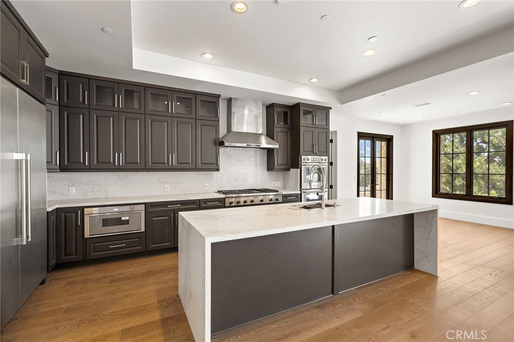 7 Alexa Lane Ladera Ranch, CA 92694 - Photo 25 of 75 a kitchen with stainless steel appliances granite countertop a stove a sink and a microwave