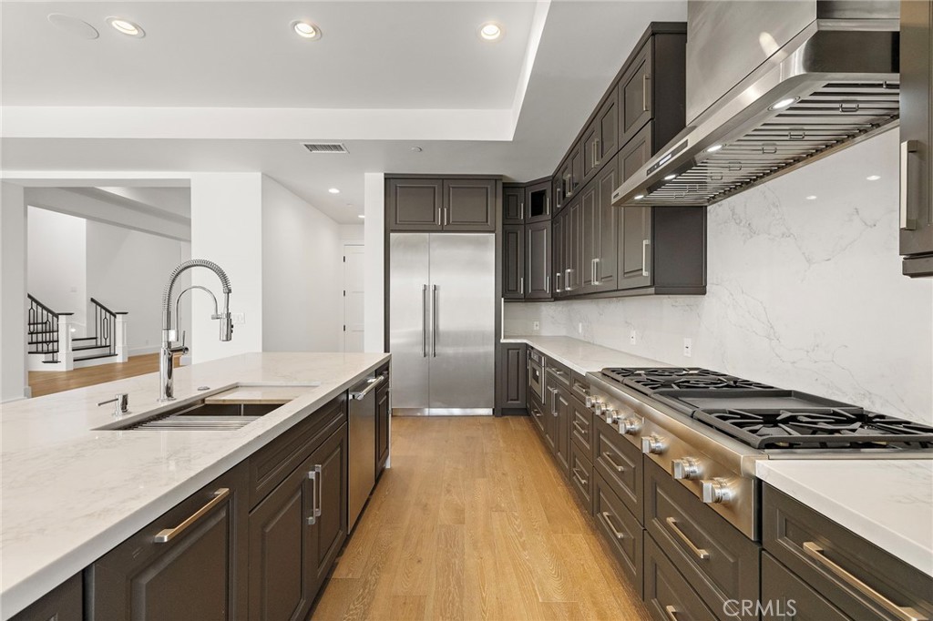 7 Alexa Lane Ladera Ranch, CA 92694 - Photo 26 of 75 a kitchen with granite countertop a sink stainless steel appliances and cabinets