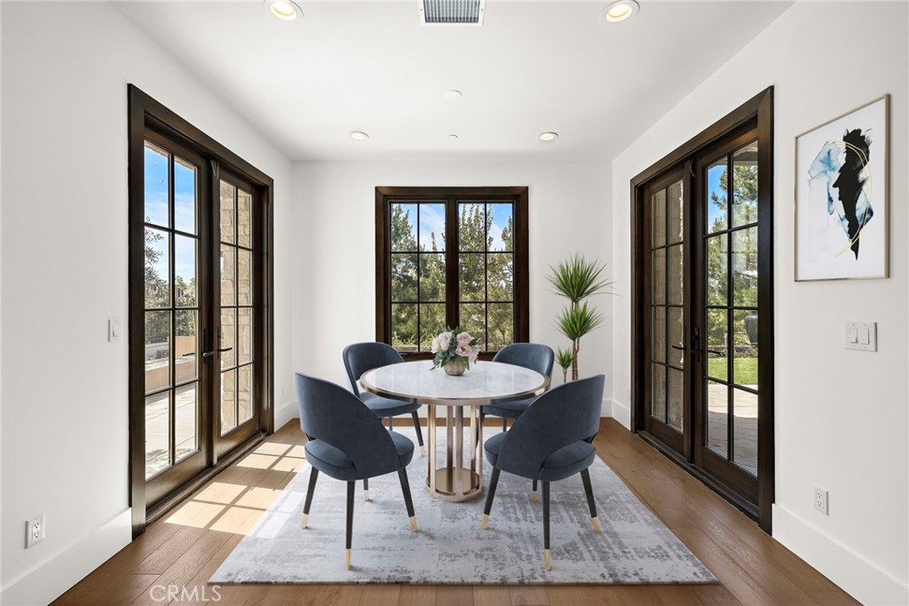 7 Alexa Lane Ladera Ranch, CA 92694 - Photo 30 of 75 a dining room with furniture a rug and wooden floor