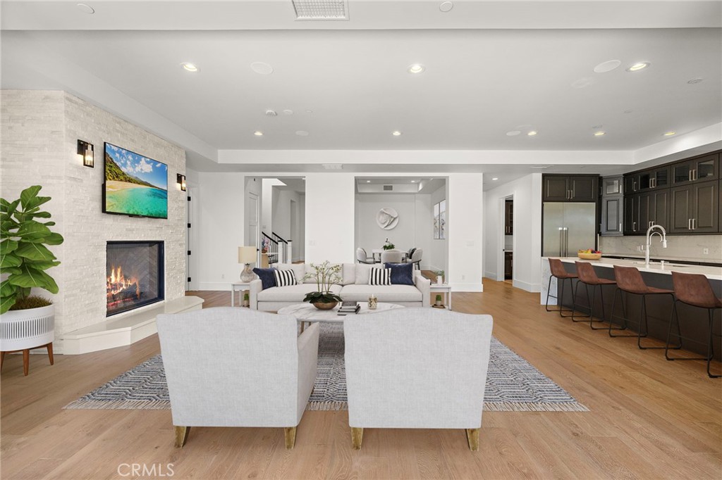 7 Alexa Lane Ladera Ranch, CA 92694 - Photo 36 of 75 a living room with fireplace furniture and a wooden floor
