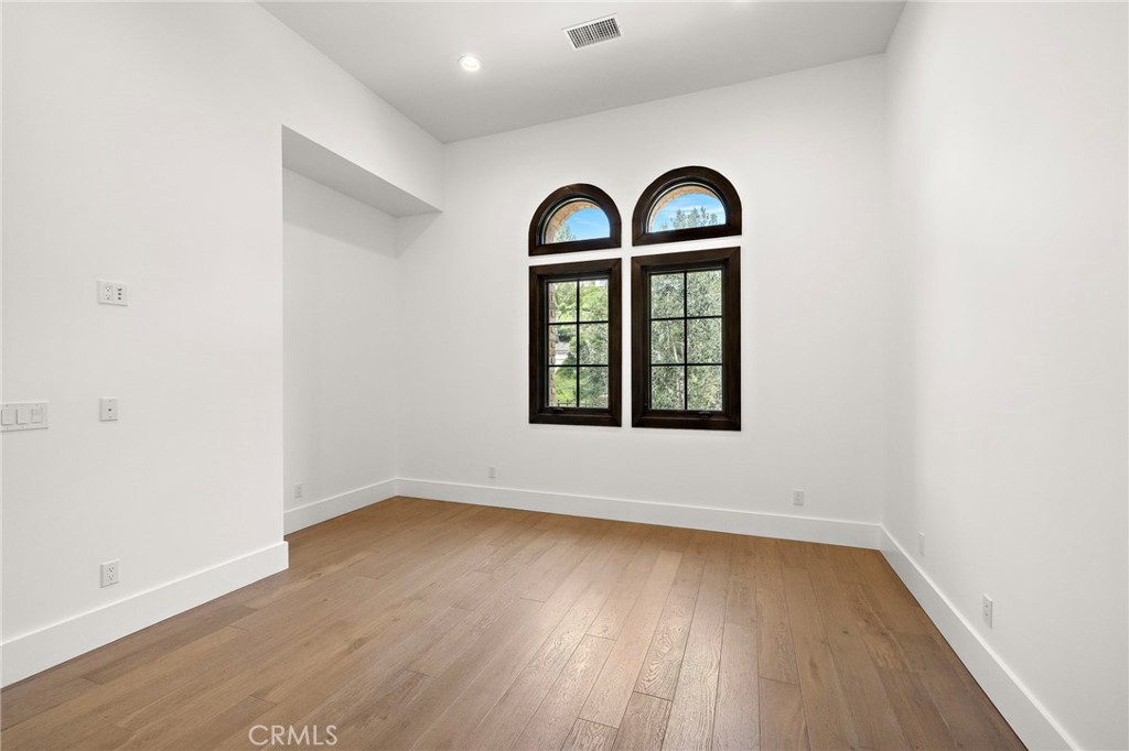 7 Alexa Lane Ladera Ranch, CA 92694 - Photo 50 of 75 an empty room with wooden floor windows and entryway