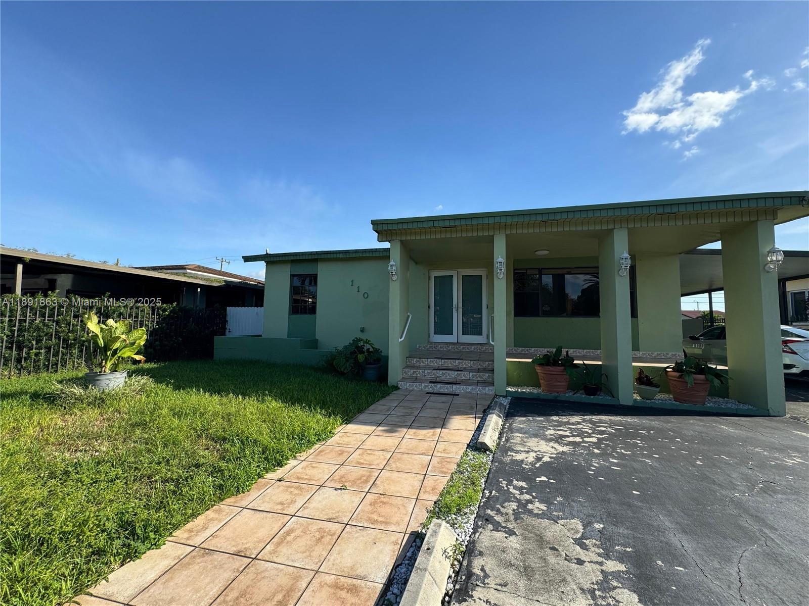 110 West 44th Street, Unit 110 Hialeah, FL 33012 - Photo 1 of 10 a front view of a house having patio