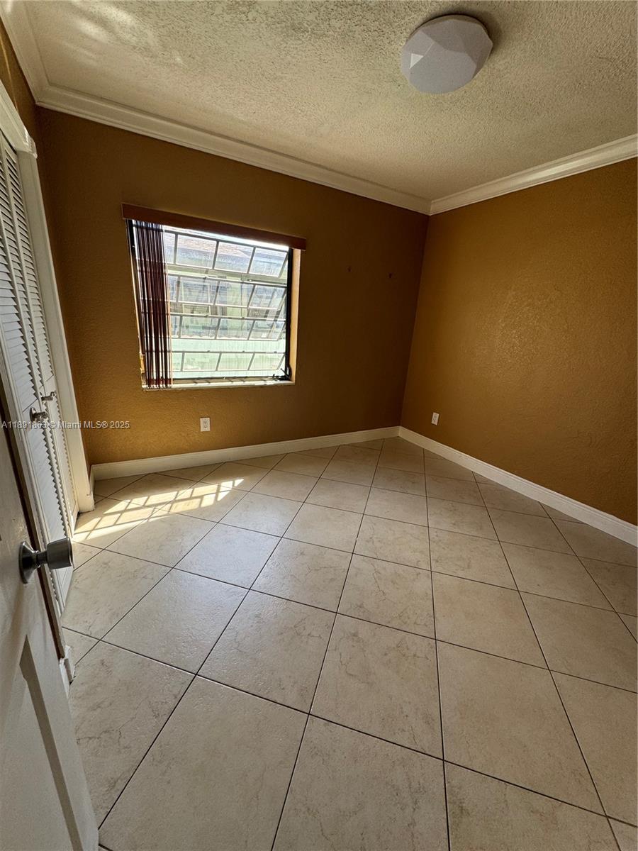 110 West 44th Street, Unit 110 Hialeah, FL 33012 - Photo 7 of 10 a view of an empty room with a window