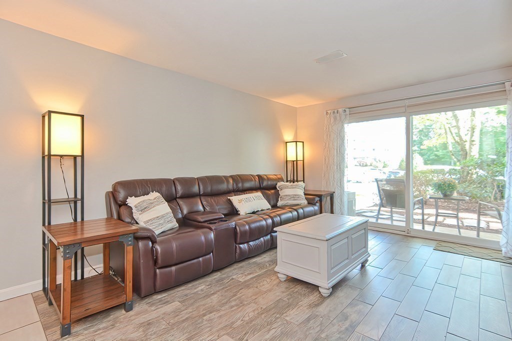 801 Franklin Crossing Road, Unit 801 Franklin, MA 02038 - Photo 11 of 38 a living room with furniture and a large window