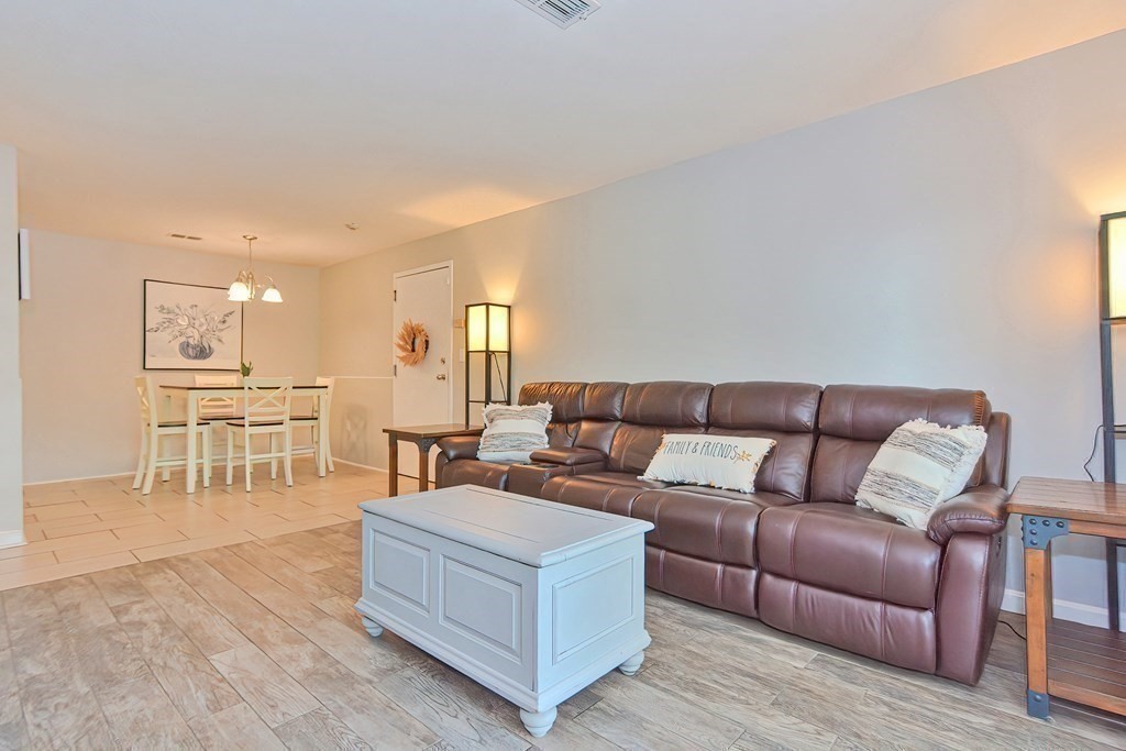 801 Franklin Crossing Road, Unit 801 Franklin, MA 02038 - Photo 14 of 38 a living room with furniture and a wooden floor