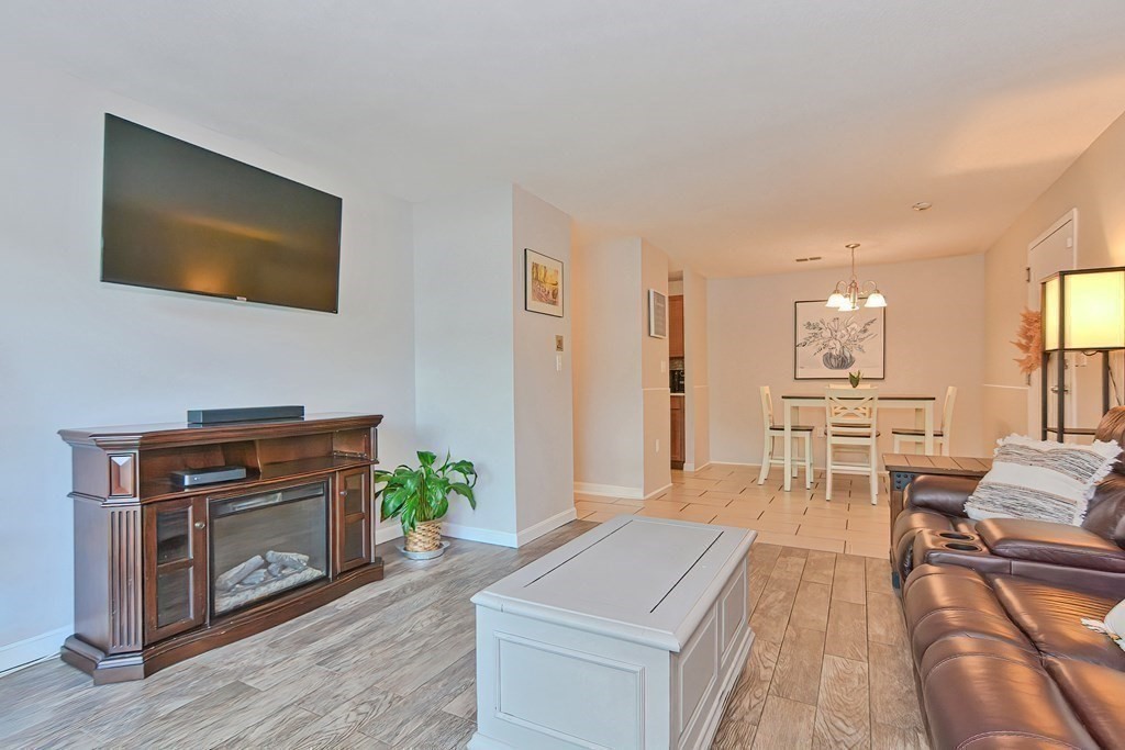801 Franklin Crossing Road, Unit 801 Franklin, MA 02038 - Photo 15 of 38 a living room with furniture and a fireplace