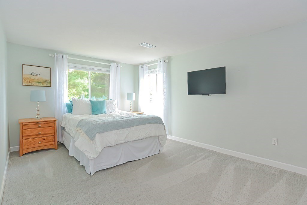 801 Franklin Crossing Road, Unit 801 Franklin, MA 02038 - Photo 18 of 38 a bedroom with a bed and a flat screen tv
